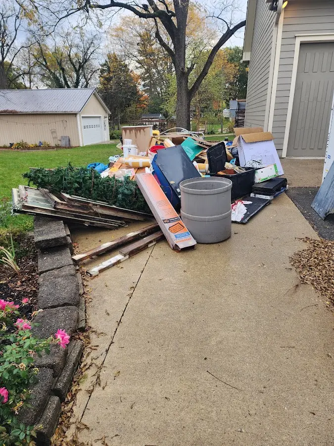 Dumpster being loaded with debris for Residential Dumpster Rental in Covington
